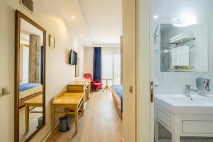a hotel room with a sink and a bedroom at Minerva Hotel Kızkalesi in Kizkalesi +144 photos