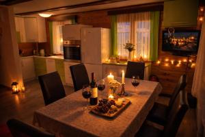 a table with candles and wine bottles on it in a kitchen at Hiška Arijela, Terme Čatež, oaza sprostitve, Slovenija in Brežice