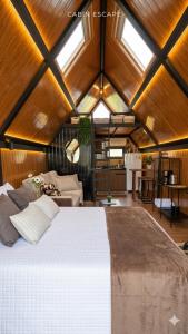 a bedroom with a large white bed in a room at Chalés da colina em Victor Graeff in Cochinho