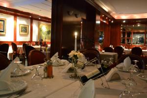 a dining room with a long table with a candle at Hotel Dva Bisera in Ohrid