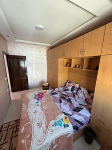 a bedroom with a bed with a quilt on it at Dar AMIRA in Ben Yakhlef