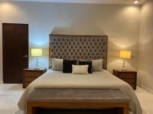 a bedroom with a large bed with two lamps at Increible Casa con vista al mar in La Paz