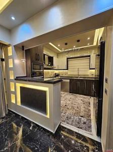 a large kitchen with a large island in the middle at دوبلكس شرق in Madīnat ash Shurūq