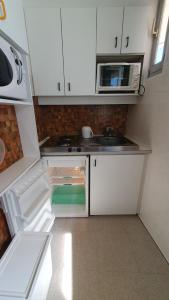 a small kitchen with a sink and a stove at appartement 4 places centre-ville in Cauterets +1 photo