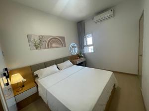 a bedroom with a large white bed and a window at Homestay THAIPHONG DRAGON CASTLE Bãi Cháy in Ha Long +33 photos