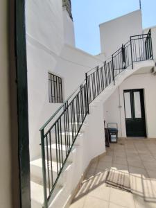 a staircase in a white building with a black door at La NICCHIA in Monteroni di Lecce