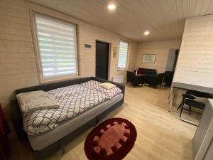a bedroom with a bed and a living room at Motel Level 2 in Miastko