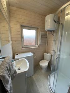 a small bathroom with a toilet and a sink at Motel Level 2 in Miastko +26 photos