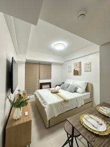 a bedroom with a large bed and a table at The Waltham Place in Lagundi