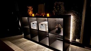a display cabinet with candles and a tea kettle on it at La loge secrète Love Room in Dolus-le-Sec +4 photos