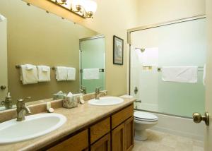 a bathroom with a sink and a toilet and a mirror at 10 Quelah Condo in Sunriver