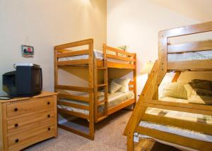 a room with two bunk beds and a television at 10 Quelah Condo in Sunriver