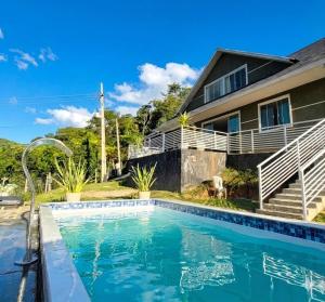 a house with a swimming pool in front of a house at Casa da Colina Curitiba com piscina in Curitiba