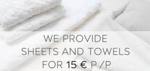 a close up of sheets and towels on a bed at Tornvillan in Hammarland