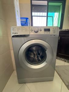a washing machine is sitting in a room at Dar AMIRA in Ben Yakhlef