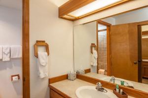 a bathroom with a sink and a large mirror at 108 Quelah Condo in Sunriver