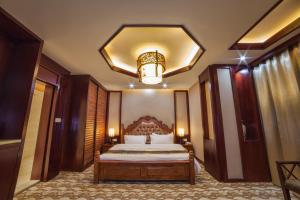 
a bedroom with a large bed and a large mirror at Hotel Shanghai City in Osh
