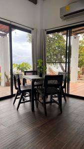 a dining room with a table and chairs and a balcony at Casa Amanecer in Tonosí