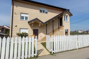 a white fence in front of a house at Familija in Belgrade