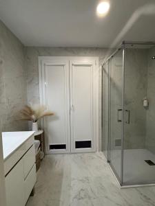 a bathroom with a shower and a glass door at Coração d`Alice in Monção +36 photos