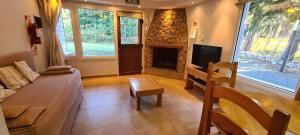 a living room with a tv and a fireplace at Laderas Verdes in Esquel
