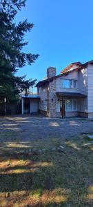 a house with a large yard in front of it at Laderas Verdes in Esquel