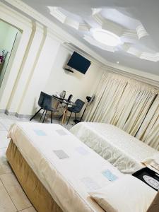 a bedroom with a bed and a table and chairs at Kingdoms Place Guesthouse in Ga-Luka