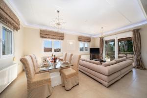 a living room with a couch and a table at Gerasimos Dream House - 7 Minutes from the Airport in Lakíthra