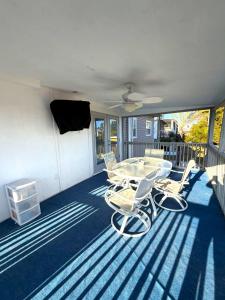 a patio with a table and chairs on a porch at Driftwood Getaway Vacation home in Fort Myers Beach