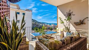 a balcony with a couch and a table with a view at Penthouse Oceanview 1 block Malecon bars shops ZR in Puerto Vallarta