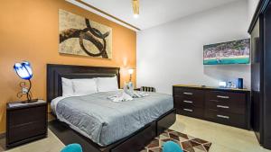 a bedroom with a bed and a dresser at Penthouse Oceanview 1 block Malecon bars shops ZR in Puerto Vallarta +10 photos