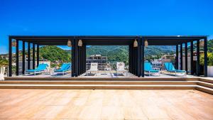 a gazebo with blue chairs on a wooden deck at Penthouse Oceanview 1 block Malecon bars shops ZR in Puerto Vallarta