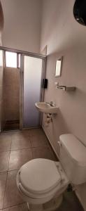 a bathroom with a toilet and a sink at Casa Rosanna in Campeche