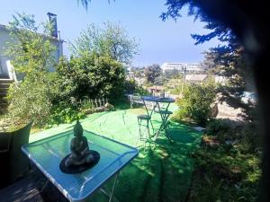 a statue sitting on a table in a garden at Ingrid Mary in Nîmes +35 photos