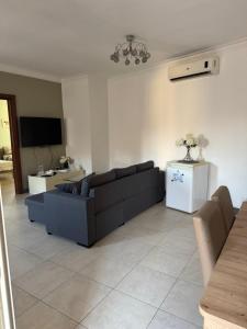 a living room with a couch and a tv at Tommy's Retreat Xewkija in Xewkija