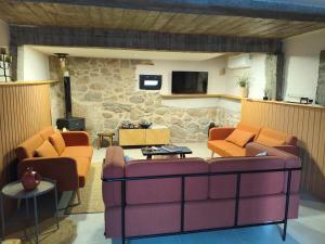 a living room with two couches and a tv at Tapada das Carvalhas in Castelo Branco