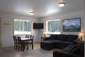 a living room with a couch and a table and chairs at The Cabins at Riptide Resort in Seward