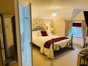 a bedroom with a bed and a window at The Old Rectory Chicklade in Chicklade