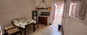 a small kitchen with a table and a door to a patio at Casa Rosanna in Campeche