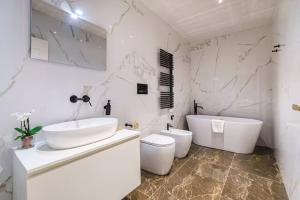 a white bathroom with a sink and a toilet at Palazzo Venezia in Florence