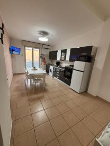 a kitchen with a table and a dining room at Ludovica's house 2 in Giardini Naxos
