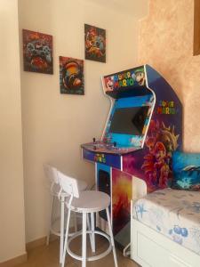 a childrens room with a video game desk and a bed at Ludovica's house 2 in Giardini Naxos +6 photos