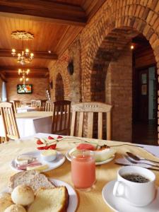 a table with a breakfast of bread and eggs and coffee at Hotel Solar de Maria in Ouro Preto