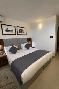 a bedroom with a large bed in a room at Five Clover Monastery Road in Lagos +21 photos