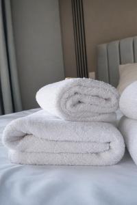 a pile of towels stacked on a bed at Mézzo Lago in Missolonghi