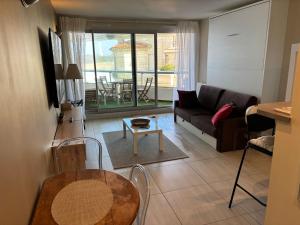 a living room with a couch and a table at Prince Studio front de mer - residence luxe & thalasso in Biarritz