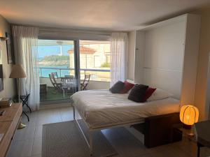 a bedroom with a bed with a view of a balcony at Prince Studio front de mer - residence luxe & thalasso in Biarritz