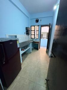 a room with a hallway with a door and a floor at Apna Ghar in Bhopal