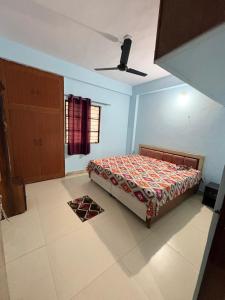 a small bedroom with a bed and a window at Apna Ghar in Bhopal