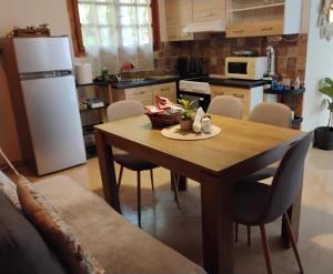 a kitchen with a wooden table and a white refrigerator at FELINA HOUSE in Artemida +44 photos